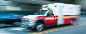 Peter Wachowski Wrongful Death Lawsuits. Photo of an ambulance speeding down city street.