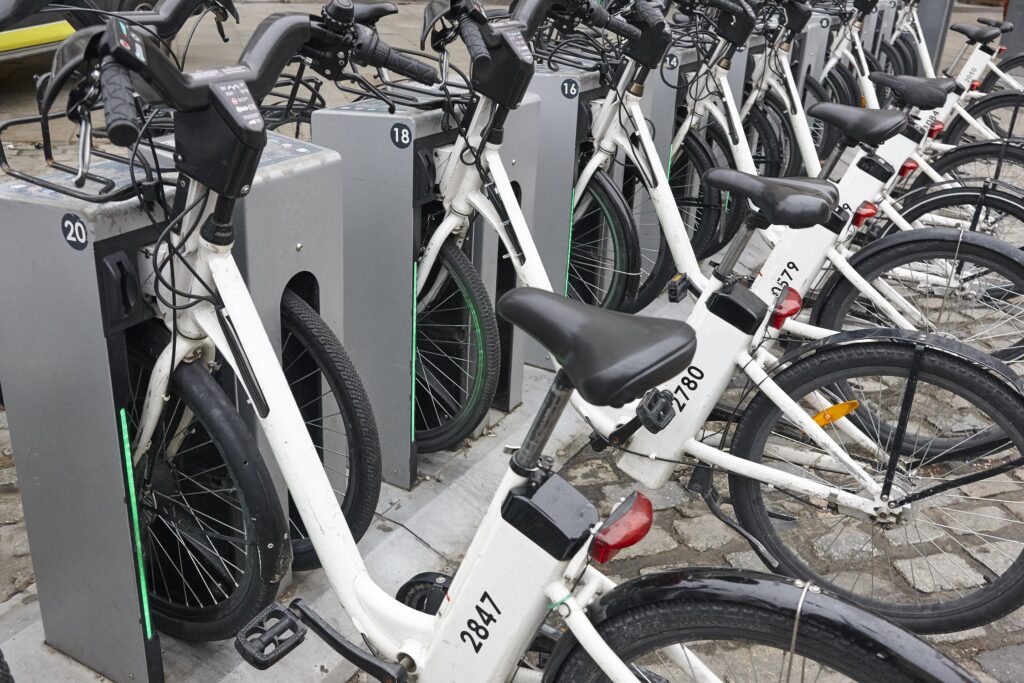 Micro-Mobility, E-Bikes, & The Law blog. Photograph of a line of e-bikes in a charging station.