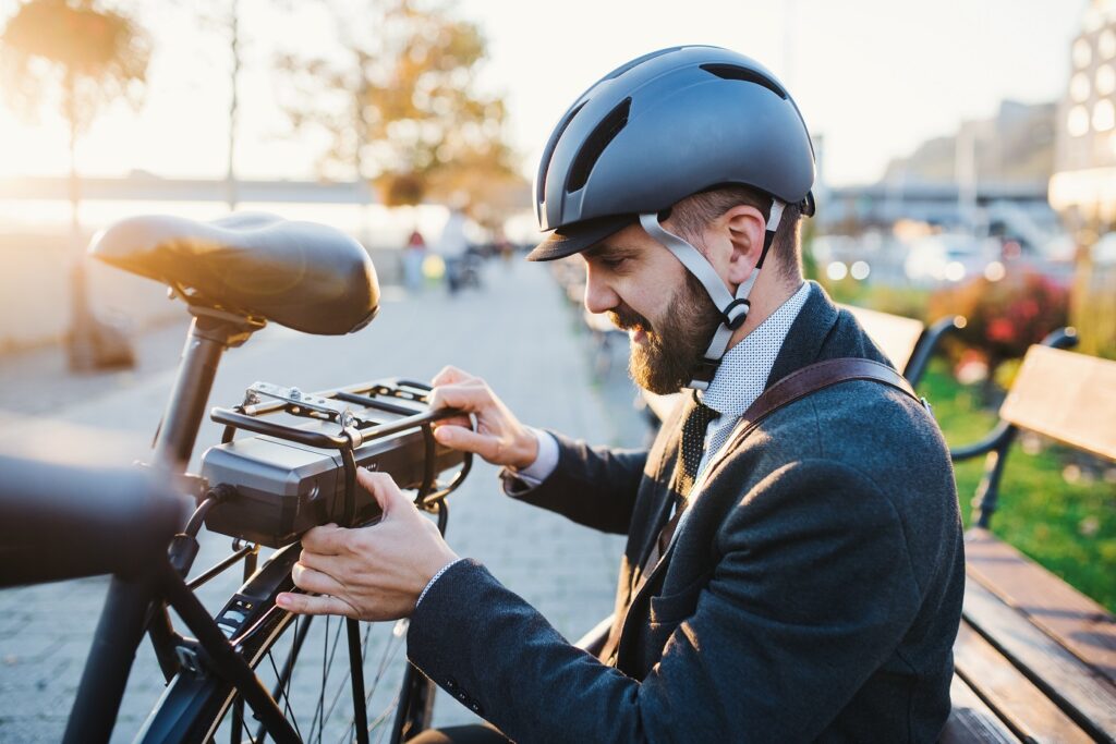Micromobility Safety blog. Image of a man checking on the safety of his bike.