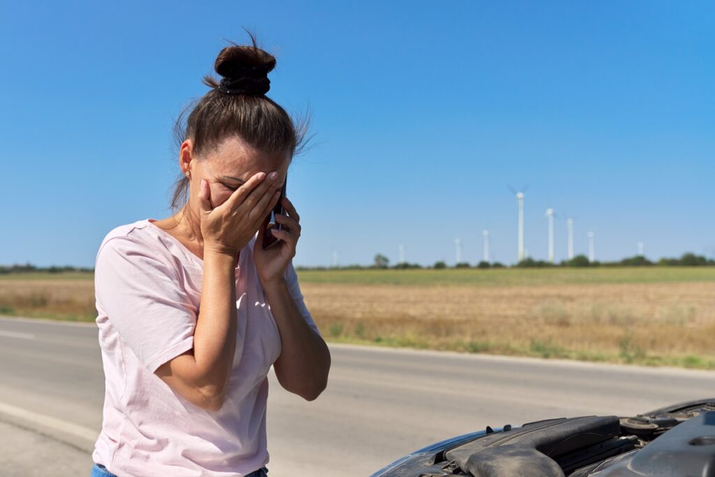 Permissive Use Accidents & Personal Injuries blog. Photo of a woman crying on the roadside of a highway.